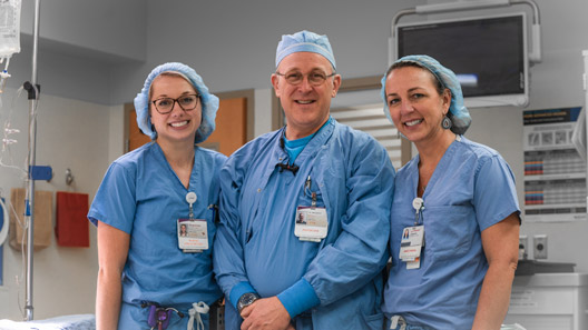 Two female nurses and one male doctor.