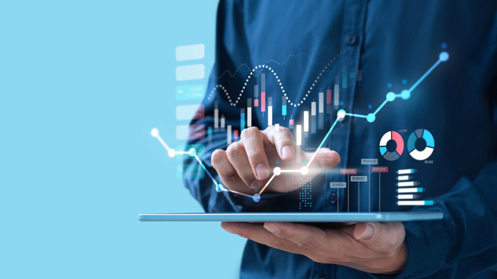 A man holding a tablet with graphs and charts on it.